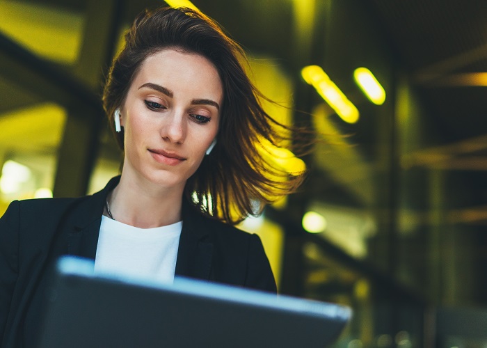 business woman on laptop with breeze blowing through hair