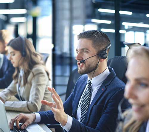 Man in a call center office speaking on the phone